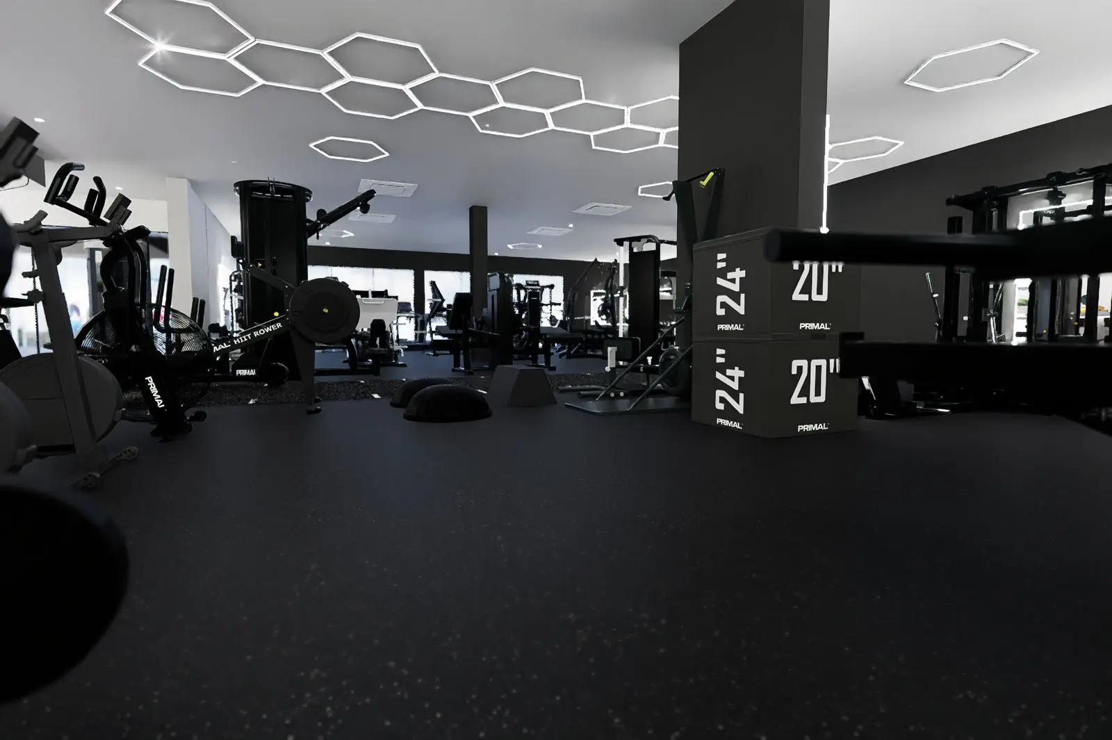 Interior of TenTenBody Club, a luxury St. Maarten gym featuring Primal Strength equipment, functional training area, and modern geometric lighting design.